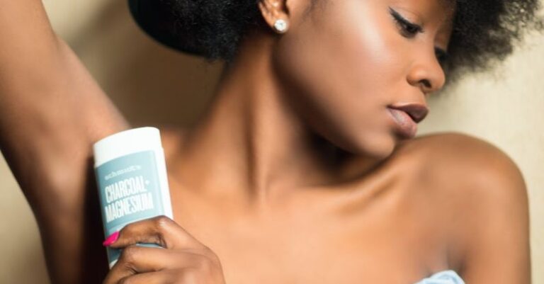 Deodorant - Woman Wearing Blue Strapless Dress Holding White and Gray Plastic Bottle