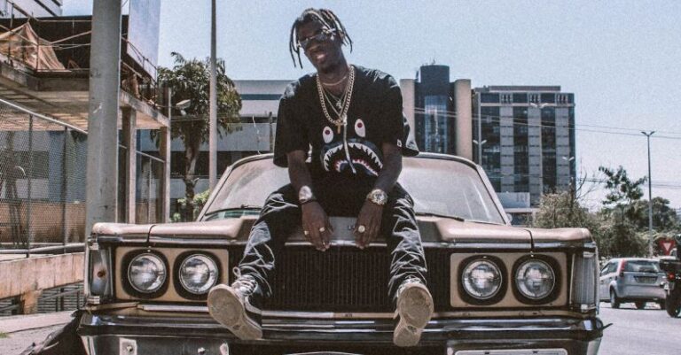 Streetwear - Photo of Man Sitting on Car Hood