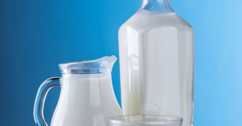 Products - Close-up of Milk Against Blue Background
